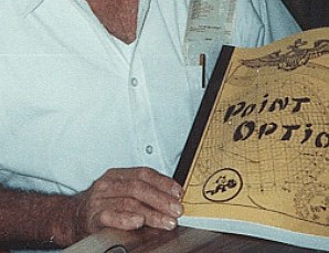 Margie and Buzzy Baur holding a copy of first editon of PONINT OPTION